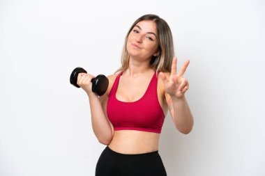 Young sport Rumanian woman making weightlifting isolated on white background happy and counting three with fingers clipart