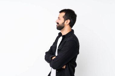 Young man with beard over isolated white background in lateral position