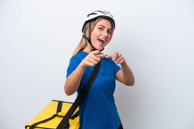 Young caucasian woman with thermal backpack isolated on white background pointing to the front and smiling