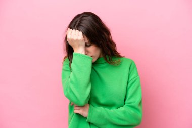 Pembe arka planda izole edilmiş, başı ağrıyan beyaz bir kadın.