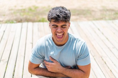 Açık havada gülümseyen genç bir İspanyol.