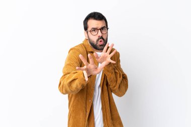 Beyaz arka plan üzerinde kadife ceket giyen beyaz saçlı, sakallı yakışıklı bir adam ellerini öne uzatıyor.