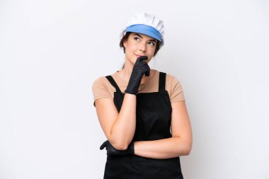 Fishmonger brazilian woman wearing an apron isolated on white background and looking up