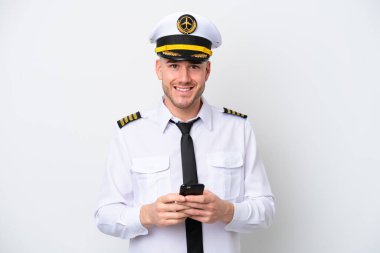 Airplane caucasian pilot isolated on white background sending a message with the mobile