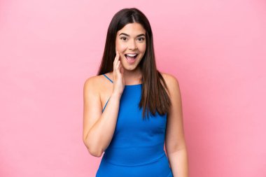 Young Brazilian woman isolated on pink background with surprise and shocked facial expression