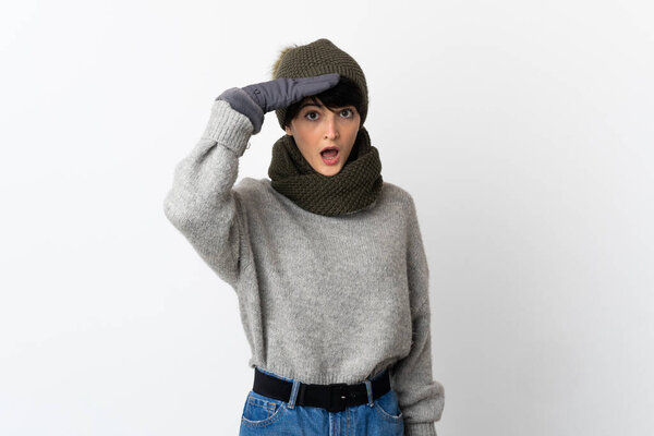 Young girl with winter hat doing surprise gesture while looking to the side