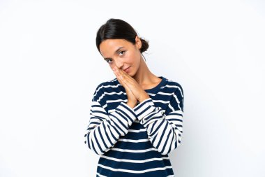 Young hispanic woman isolated on white background keeps palm together. Person asks for something