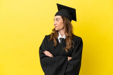 Sarı arka planda izole edilmiş orta yaşlı üniversite mezunu.