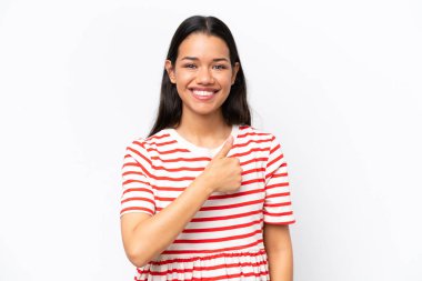 Beyaz arka planda izole edilmiş genç Kolombiyalı kadın baş parmak işareti yapıyor.