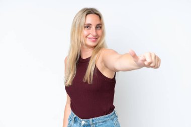 Beyaz arka planda izole edilmiş genç beyaz bir kadın baş parmak hareketi yapıyor.