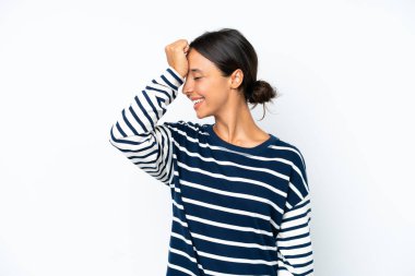 Young hispanic woman isolated on white background has realized something and intending the solution