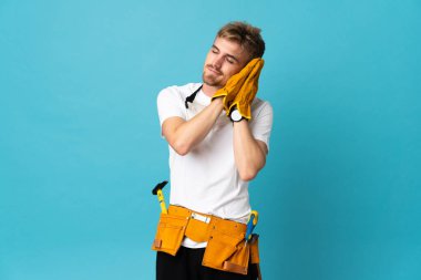 Genç elektrikçi, izole duvarın üzerinden uyku jesti yapıyor.