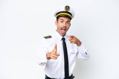Airplane pilot over isolated white background pointing to the front and smiling