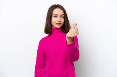 Young Ukrainian woman isolated on white background making money gesture