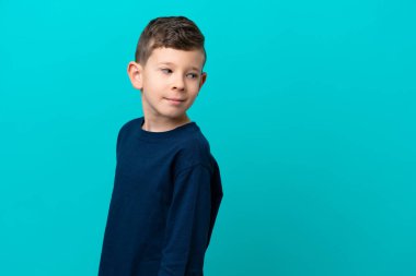 Küçük çocuk mavi arka planda izole edilmiş. Portre