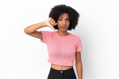 Beyaz arka planda izole edilmiş genç Afrikalı Amerikalı kadın, olumsuz ifadeyle baş parmağını aşağı gösteriyor.