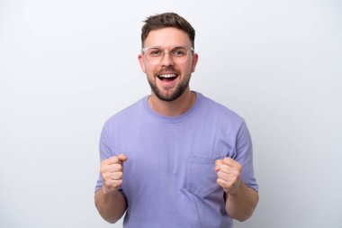 Beyaz arka plandaki beyaz tenli genç adam galibiyeti kutluyor.