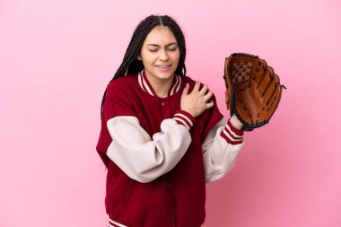 Beyzbol eldivenli genç oyuncu, pembe arka planda izole edilmiş ve omuz ağrısı çekiyor.