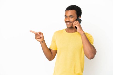 İzole edilmiş beyaz arka plan üzerinde cep telefonu kullanan Afro-Amerikalı yakışıklı bir adam.