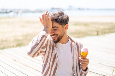 Açık havada kornet dondurmalı yakışıklı bir Arap bir şeyin farkına vardı ve çözümü arıyor.