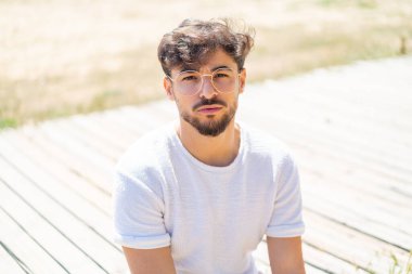 Dışarıdaki yakışıklı Arap gözlüklü adam.