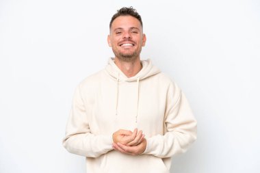 Beyaz arka planda izole edilmiş beyaz tenli yakışıklı bir adam gülüyor.