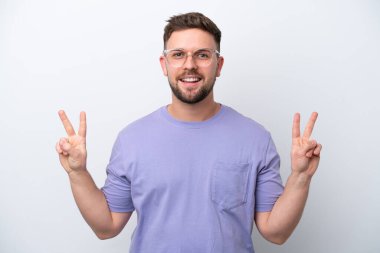 Young caucasian man isolated on white background showing victory sign with both hands