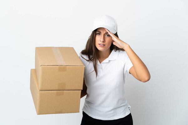 Young delivery woman over isolated white background looking far away with hand to look something