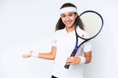 Young tennis player woman isolated on white background extending hands to the side for inviting to come