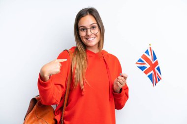 Beyaz arka planda izole edilmiş bir Birleşik Krallık bayrağı tutan genç İspanyol kadın geliyor.