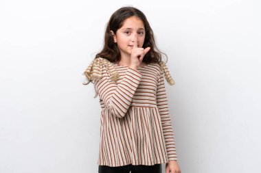 Beyaz arka planda izole edilmiş küçük bir kız sessizlik işareti gösteriyor. Parmağını ağzına sok.