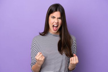 Young Brazilian woman isolated on purple background frustrated by a bad situation