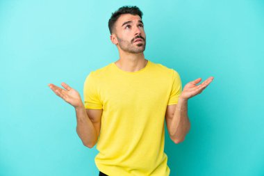 Mavi arka planda izole edilmiş genç beyaz adam bunalıma girdi.