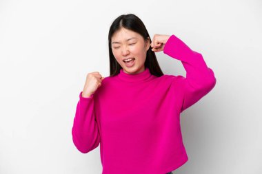 Young Chinese woman isolated on white background celebrating a victory