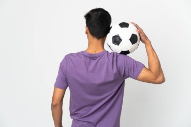Young man over isolated white background with soccer ball