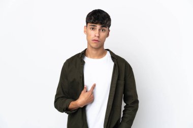 Young man over isolated white background pointing to oneself