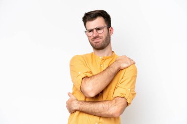 Young caucasian man isolated on white background suffering from pain in shoulder for having made an effort