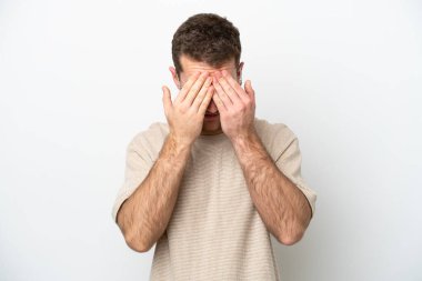 Beyaz arka planda izole edilmiş, yorgun ve hasta bir yüzü olan genç beyaz bir adam.