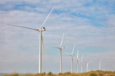 Rotterdam, The Netherlands - October 12, 2022: Row of new wind turbine of the Dutch energy supplier Eneco on the Maasvlakte in Rotterdam, The Netherlands
