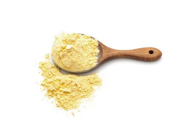 Corn flour poured from wooden spoon on white background