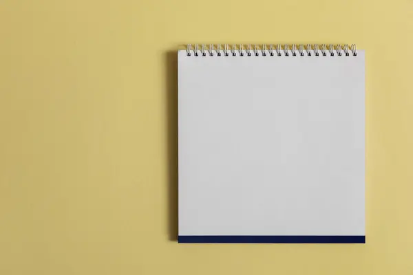 黄底空白纸书桌螺旋式日历 免版税图库照片