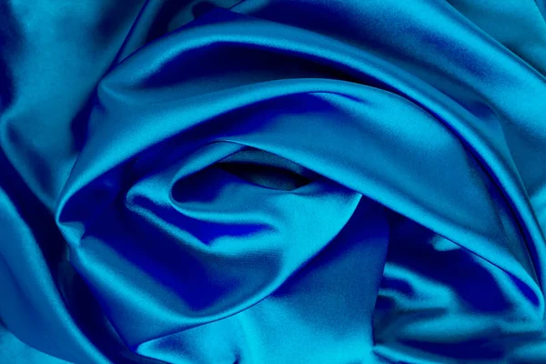 Textile background. Blue silk. Close-up. Top view.