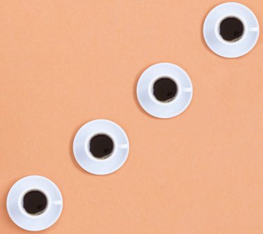 Açık kahverengi arka planda beyaz kahve fincanları. Şablon. Düz yatıyordu. Boşluğu kopyala.