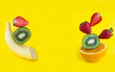 Collage. Pyramid of fruit and berry in balance on the yellow background. Copy space. Close-up.