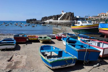 Bir yaz gününde renkli tekne ve deniz feneri manzarası. Camara de Lobos. Madeira. Portekiz.