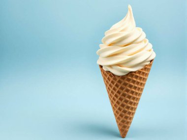 Vanilla ice cream in a waffle cone on a blue background. Copy space.