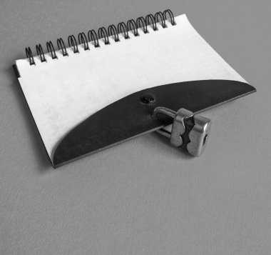 Notebook on a spring closes with a small padlock for security