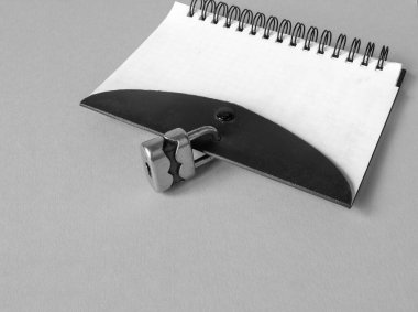Notebook on a spring closes with a small padlock for security