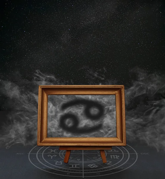 Abstract image of the sign of the zodiac Cancer against the background of the starry sky and smoke in a frame on a stand