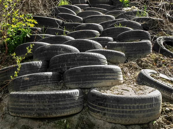 stock image Old car tires stacked in layers to strengthen the slope